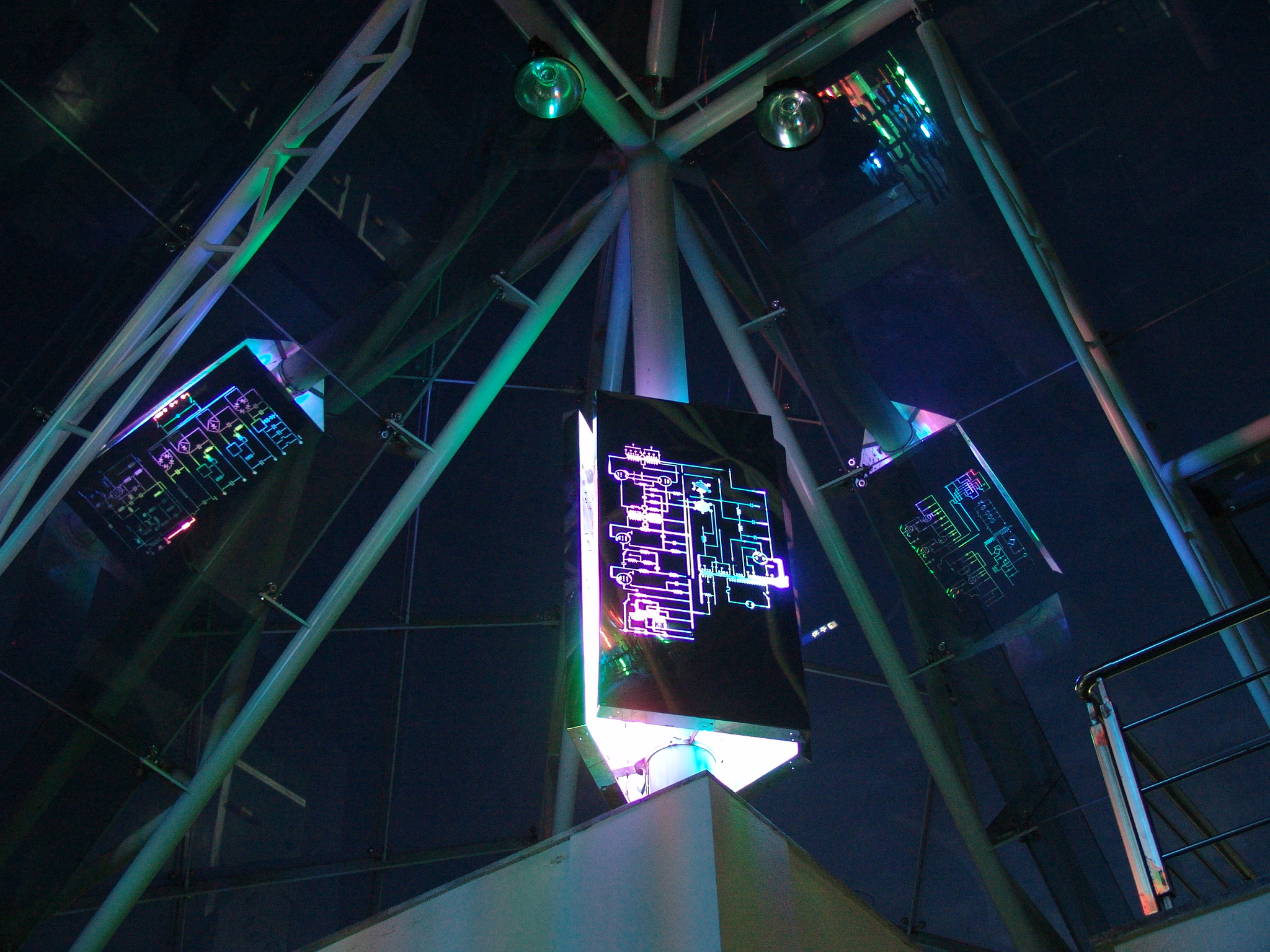 Detail view showing light waves and circuit-like layers meeting the glass pyramid structure